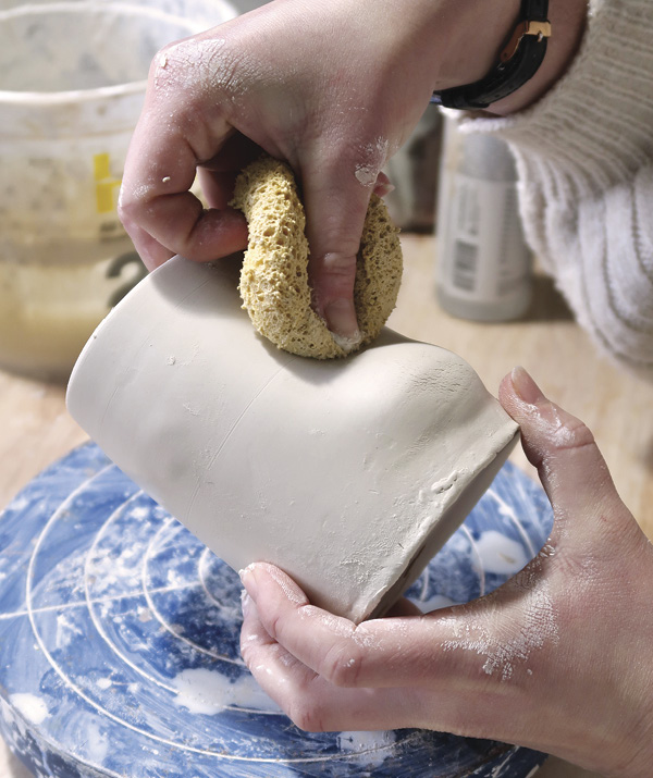 3 Belly the inside of the mug outward and use a sponge to place a dimple on the exterior where the handle will go.