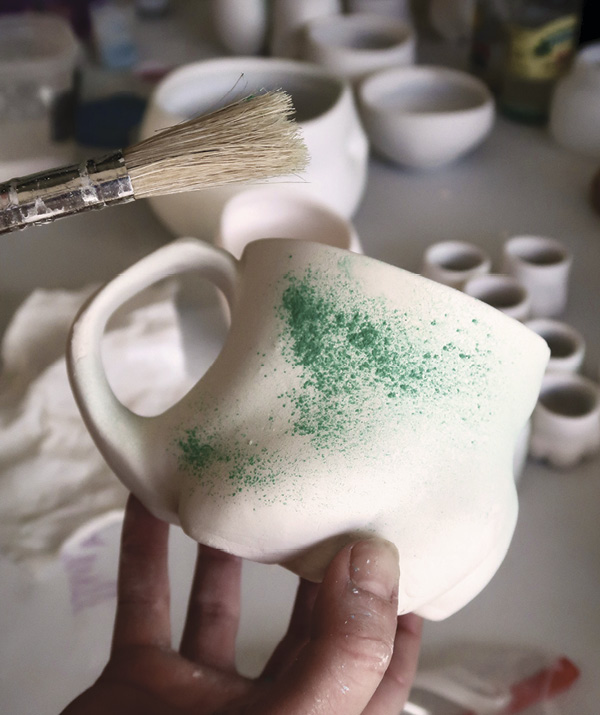 19 Use a paint brush to sprinkle copper carbonate on the surface to produce specks of red.